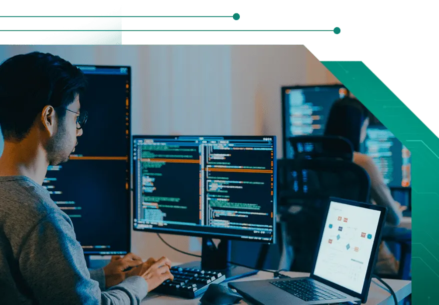 Man working on a computer, representing secure cloud-based system control and real-time monitoring